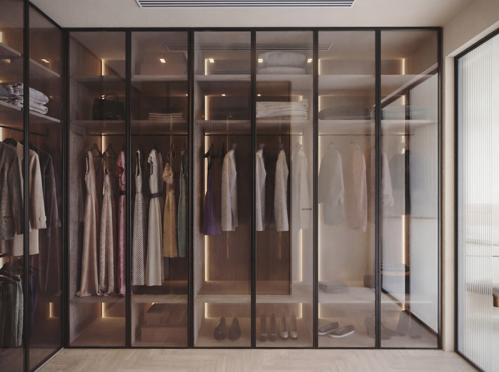 A modern dressing room featuring a cohesive layout of custom wardrobes and refined finishes, designed with a balanced mix of warm materials and soft lighting to create an elegant, functional, and calm personal space