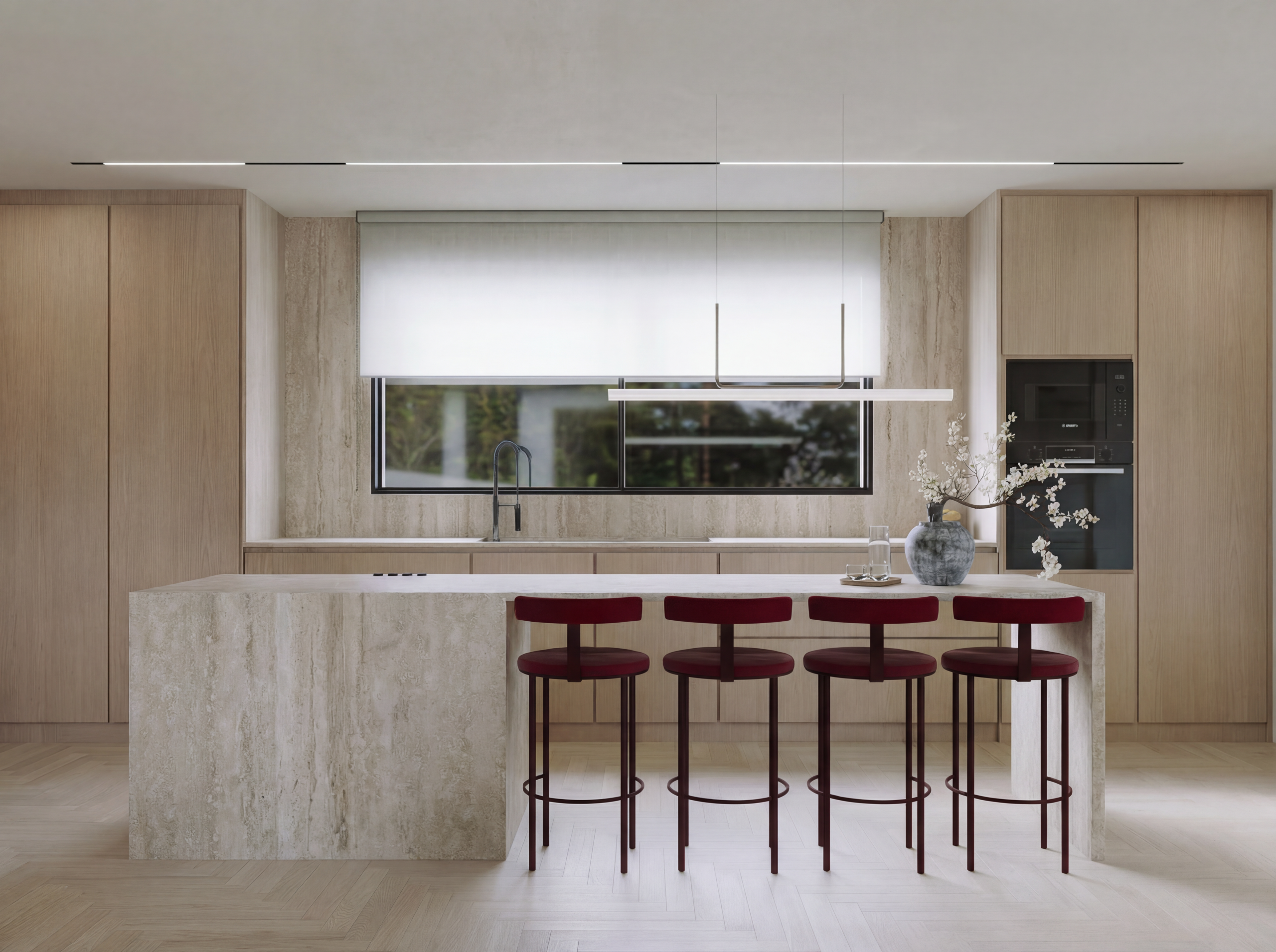 Light wood kitchen with soft neutral tones accented by bold burgundy chairs adding a warm, stylish contrast
